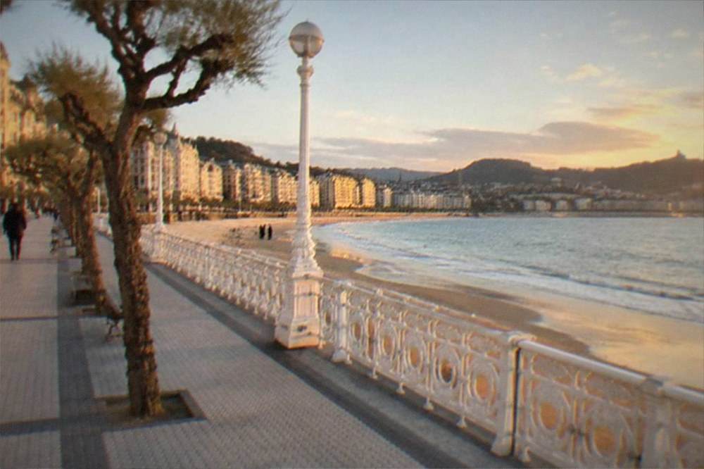 Evening light on the buildings and promenade along La Concha bay in San Sebastián