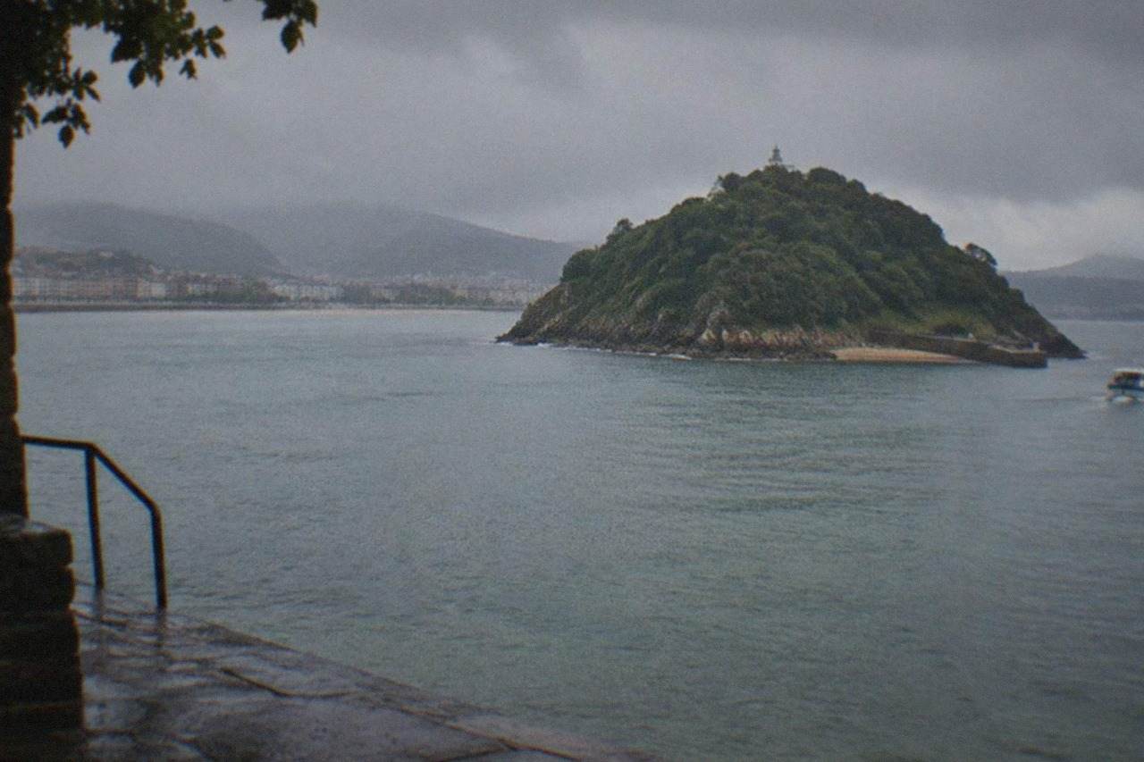 Rain clouds over La Concha bay in San Sebastián with the Santa Clara island in the distance