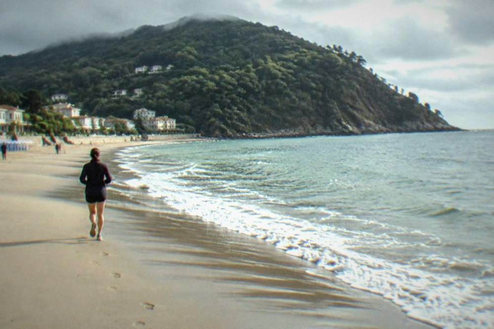 Clouds rolling over the green hills above Ondarreta beach in San Sebastián
