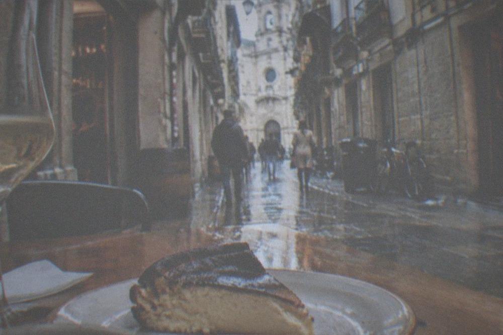 A slice of burnt Basque cheesecake on a plate in a San Sebastián bar