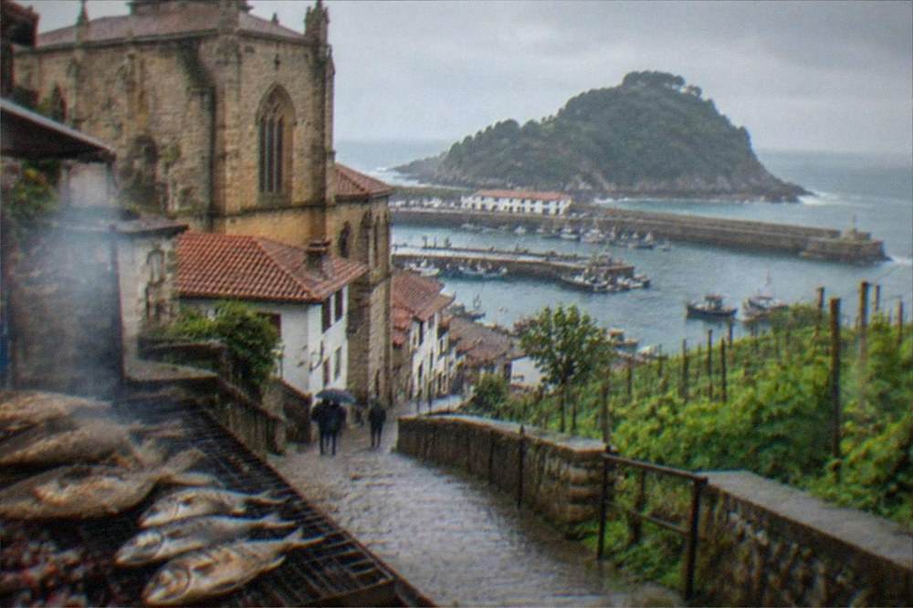 Fishing boats and stone houses in the harbour of Getaria on the Basque coast