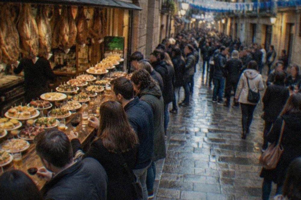 A crowded Old Town street in San Sebastián in the evening with festival decorations and people outside pintxo bars