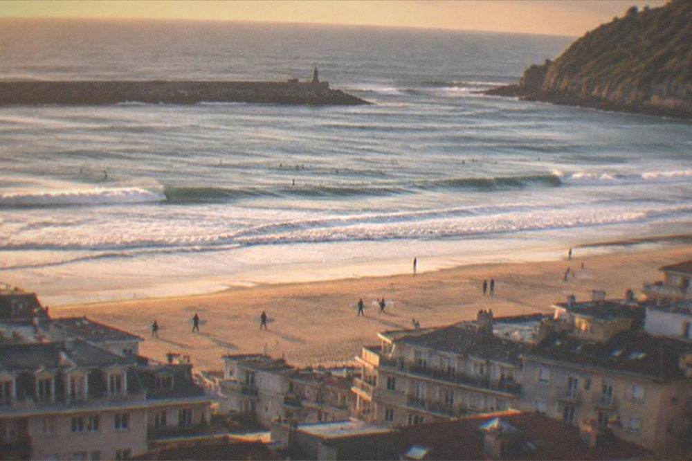 Evening light over Gros rooftops with Zurriola beach and the ocean beyond
