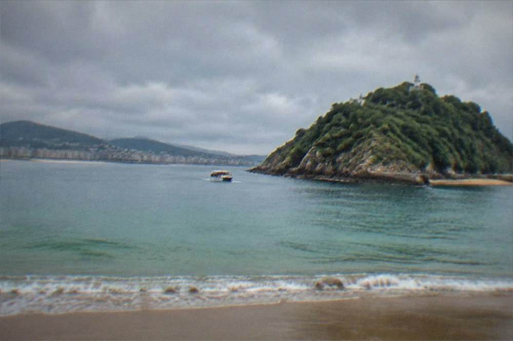 Rain clouds over La Concha bay and the Santa Clara island from the San Sebastián seafront