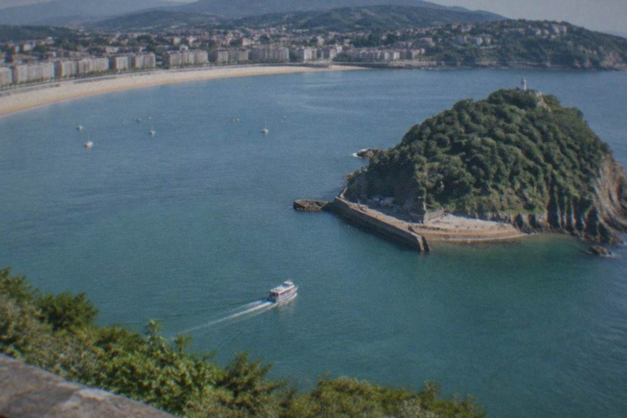 The sandy curve of La Concha beach in San Sebastián with Santa Clara island in the bay