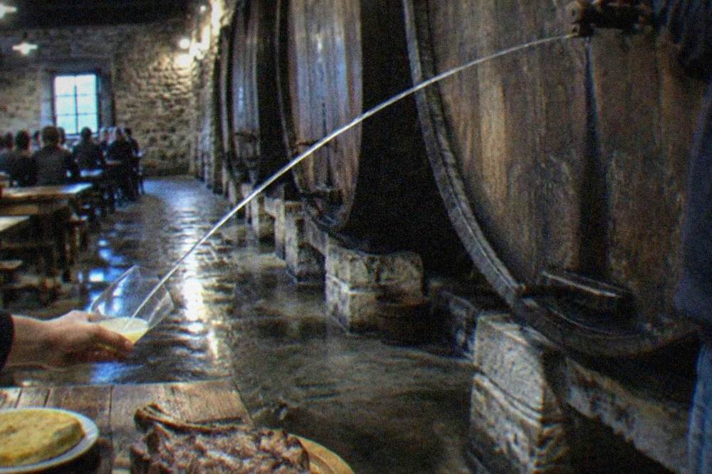 A cider barrel being broached at a Basque cider house near San Sebastián