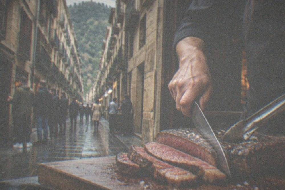 A thick txuleta steak being sliced on a board at a Basque grill restaurant
