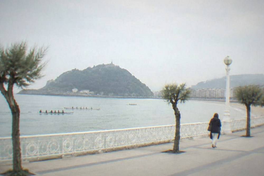 Rowing teams training on La Concha bay in front of the island and the promenade