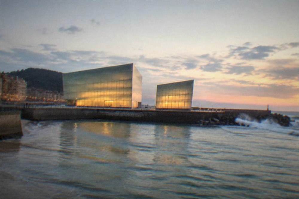 The illuminated Kursaal glass cubes beside the Urumea river at dusk