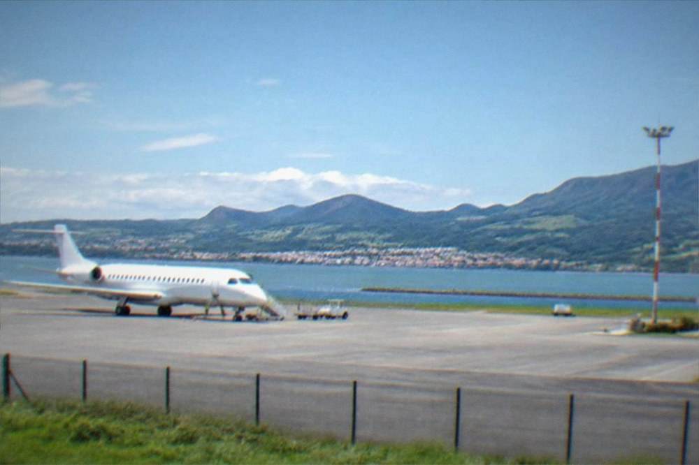 A modern train at a platform in a Basque coastal station