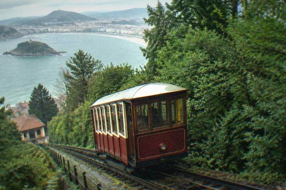 The wooden funicular car climbing the green slope of Monte Igueldo above San Sebastián