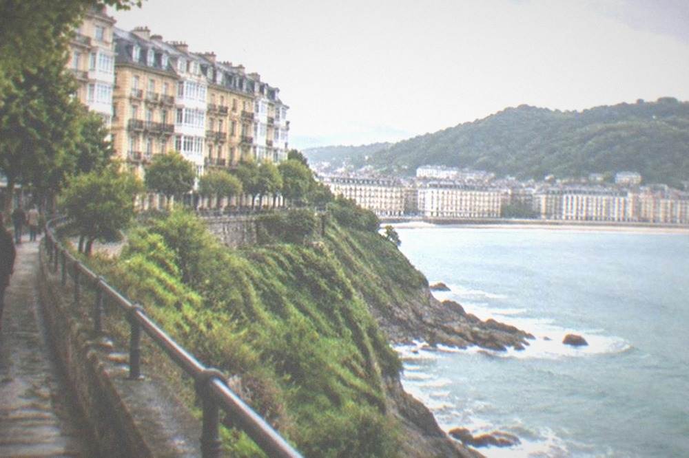 A coastal walking path above green cliffs with the sea below near San Sebastián