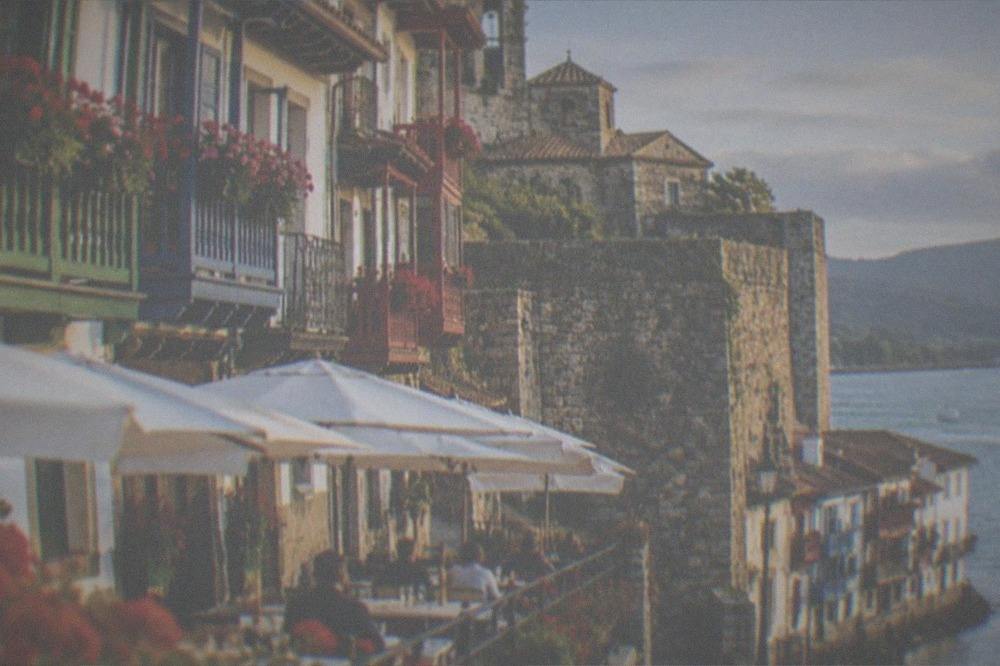 The walled old quarter of Hondarribia with colourful wooden balconies above a restaurant terrace