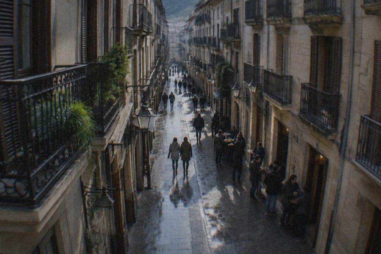 Wet pavement and reflections in a narrow Old Town street in San Sebastián