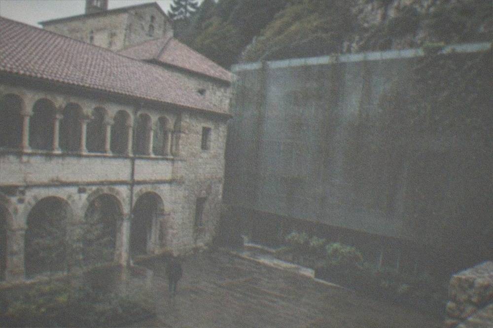 A museum courtyard with stone arches under an overcast sky