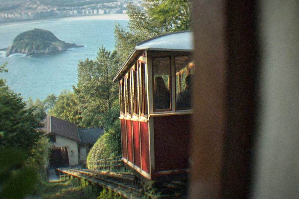 The funicular railway on Monte Igueldo with wooden cars and the bay behind