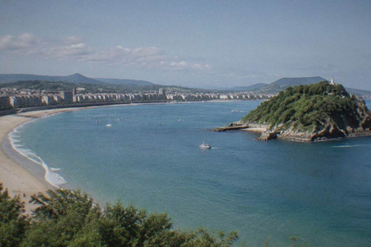 La Concha beach curving around the bay in San Sebastián with Santa Clara island offshore