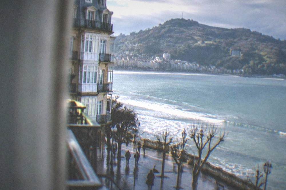 A coastal view of the Basque coastline near San Sebastián with green hills above the sea
