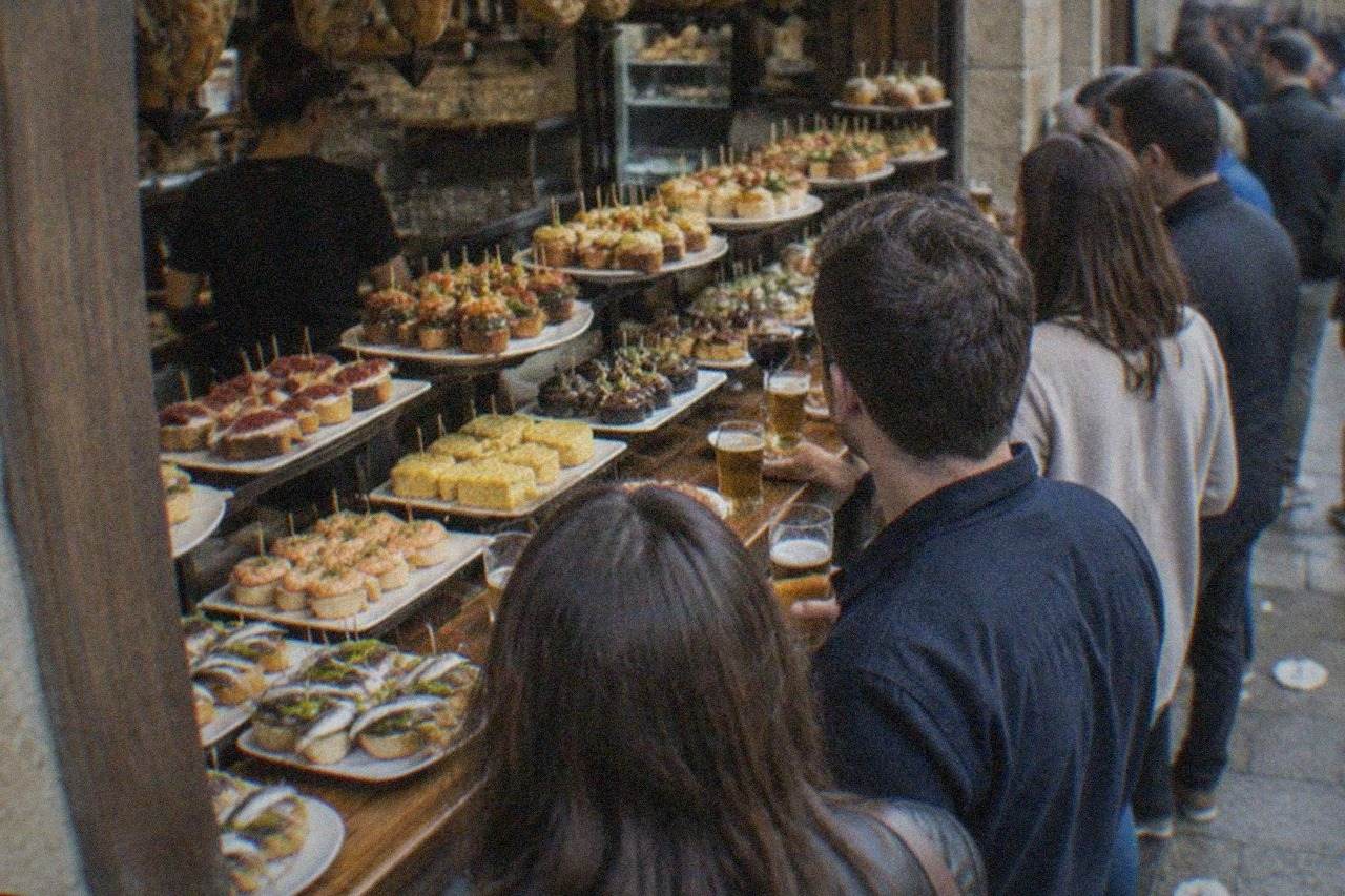 Pintxo bars with crowds standing at the counter in an Old Town street in San Sebastián