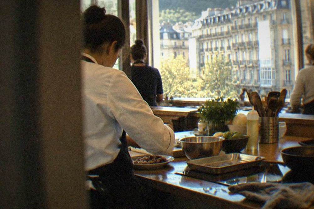 Chef preparing Basque dishes in a cooking class kitchen in San Sebastián