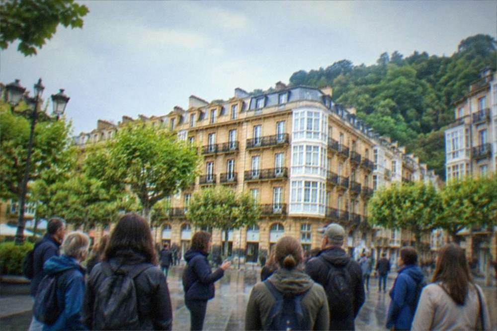 Guided walking group stopped in a plaza in the Old Town of San Sebastián